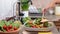 Child hands mixing vegetables in a salad