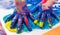 Child hands painted in colorful paints. Education, school, creativity and painting concept.