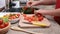 Child hands preparing tomatos for a vegetables salad