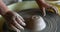 Child hands sculpt earthenware bowl on pottery wheel
