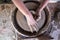 Child hands shaping bowl on potters wheel