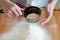 Child hands sifted flour.