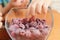 Child hands taking frozen raspberries
