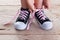 Child hands tie up shoe laces