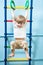 Child hanging on gymnastic rings