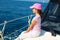 Child happy girl sailing happy boat with cap