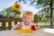 Child, having breakfast in the morning, sitting on porch of camping van, traveling summer time