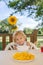 Child, having breakfast in the morning, sitting on porch of camping van, traveling summer time