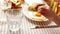 A child is having breakfast (scrambled eggs with toast and salad) while a parent pours orange juice into his glass