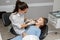 Child having dental check up by specialist in dentist office