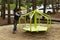 Child having fun on a spinning game in the park