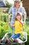 Child having fun in a wheelbarrow pushing by