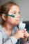 Child having medical inhalation treatment with nebuliser