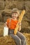 Child on a haystack with bread