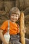 Child on a haystack with bread milk