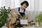 The child in the headphones engaged in planting the flowers of hyacinths, pours water from the jug