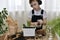 The child in the headphones engaged in planting the flowers of hyacinths, pours water from a small jug