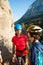 The child in helmet is instructed to go through the climbing route