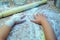 The child helps to cook the mother pizza. The child`s hands in flour