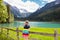 Child hiking in flower field at mountain lake