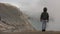 Child hiking on mountain. Foggy, smoky climate
