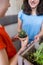 A child with his mother is choosing home plants in the store