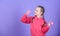 Child hold little dumbbell violet background. Beginner dumbbell exercises. Sport for teens. Easy exercises with dumbbell