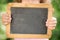 Child holding blackboard