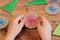 Child is holding a Christmas ball decor in his hands. Child is showing a Christmas ball decor. Simple recycled crafts