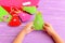 Child holding Christmas tree toy in his hands. Child showing Christmas crafts. Felt crafts ideas for kids. Scissors, thread