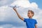 Child holding drone outdoors at summer day