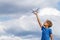 Child holding drone outdoors at summer day