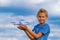 Child holding drone outdoors at summer day