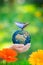 Child holding Earth planet with blue butterfly in hands