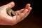 Child holding euro coin in his hand. Pocket money stock image. Poor low income group. Dark background. - Image. Close up