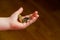 Child holding euro coin in his hand. Pocket money stock image. Poor low income group. Dark background. - Image. Close up