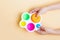 A child holding a game in his hands Anti-stress sensory fidget toy simple dimple on pastel background