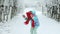Child holding gift box and surprise face. Child in red hat with Christmas gift box in snow. Winter outdoor fun. Kid play