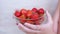 Child Holding in Hands Full Glass Bowl Red a Strawberry in Sunlight in Room. 4K