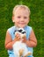 Child holding on hands of a small rabbit