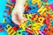 Child holding magnetic plastic letters in hands