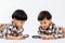 Child holding magnifying glass on white background. Boy with a magnifying glass in studio.