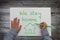 Child holding pen on blank sheet of paper. child hands drawing on desk -