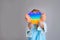 The child is holding a rainbow pop it fidget toy instead of a head.Push bubble fidget sensory toy - washable and reusable silicon