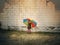 Child Holding Rainbow Umbrella Outside