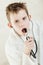 Child holding stethoscope near his mouth