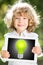 Child holding tablet PC with lightbulb