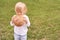 Child holds and bite round bread. Healthy food