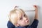 Child holds box in hands on white background. Cute little boy is happy the parcel. Top view