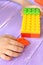 Child holds the building blocks toys in his hands and plays. Kids building blocks set that develop fine motor skills